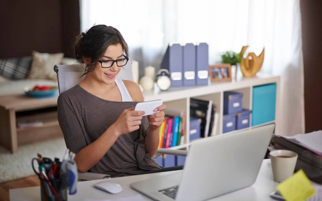 Author using social media while sitting at a desk with a computer