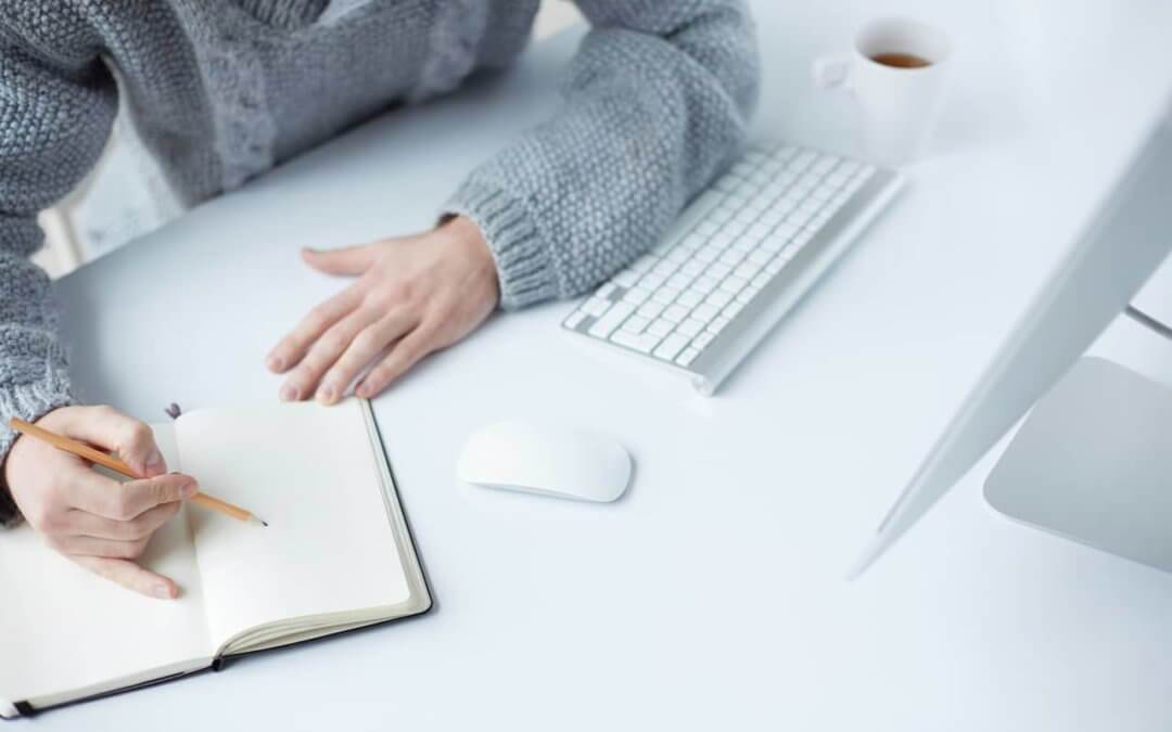 Author working on a novel in front of a computer.