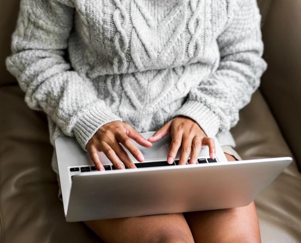 Author writing a book on a laptop.